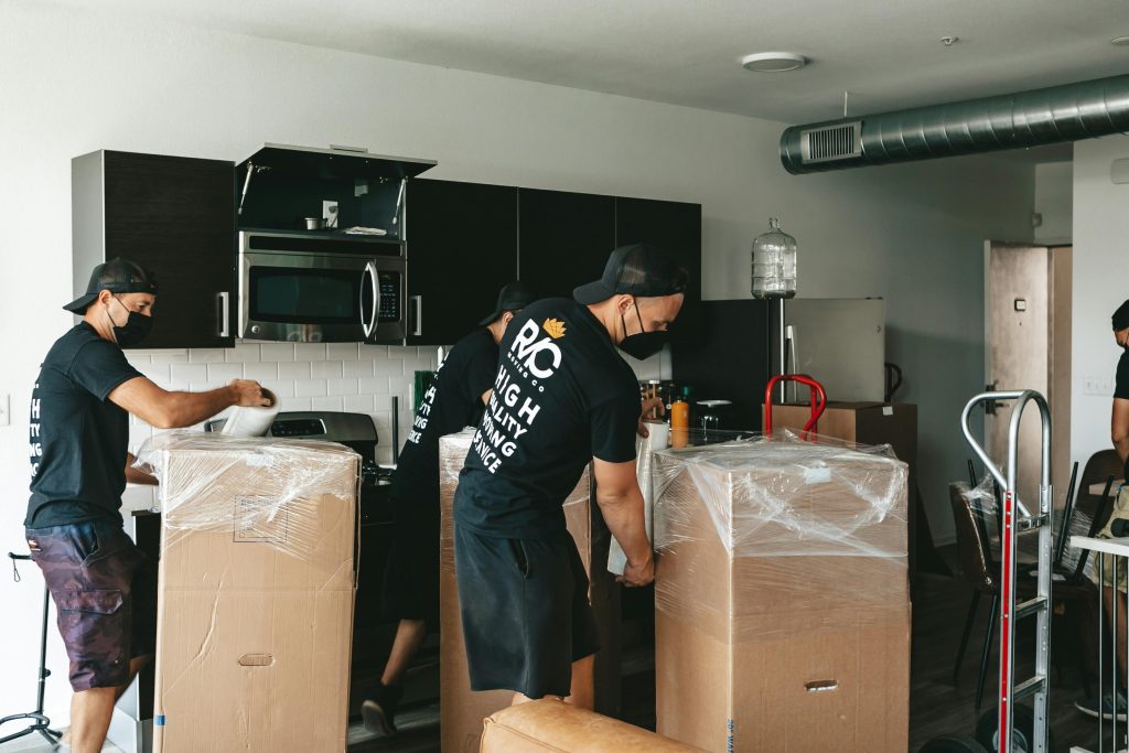 Estate cleanout crew removing furniture and clutter from a probate home.